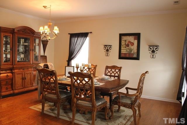 817 Stackhurst Way Wake Forest, NC 27587 - Photo 5 of 23 Formal Dining and Living Rooms feature gorgeous Hardwood Floors, another Upgrade.