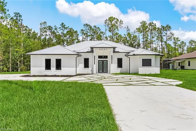 a front view of house with yard and green space
