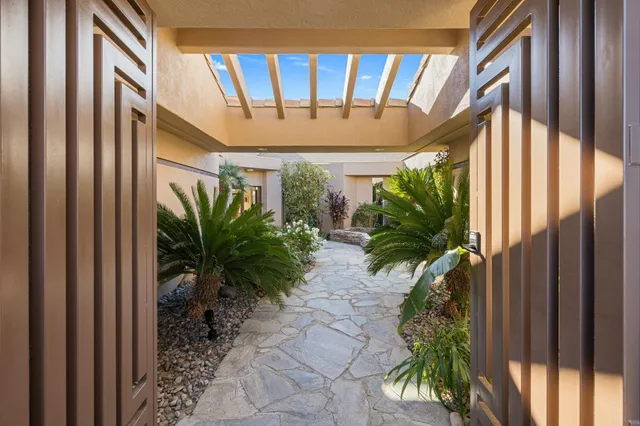 a couple of potted plants in front of door