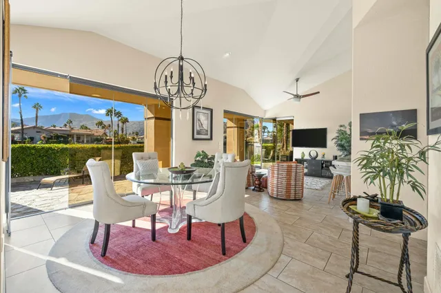 a view of a dining room with furniture wooden floor and chandelier