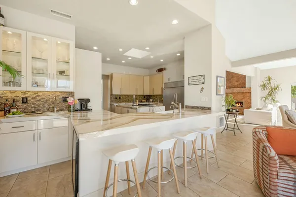 a large kitchen with lots of counter space and windows