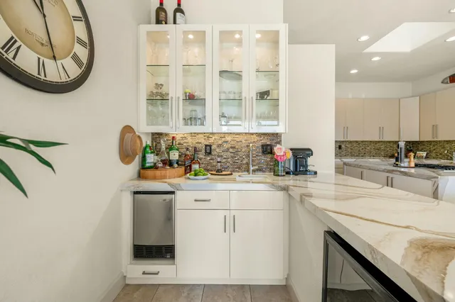 a kitchen with a white cabinets and sink