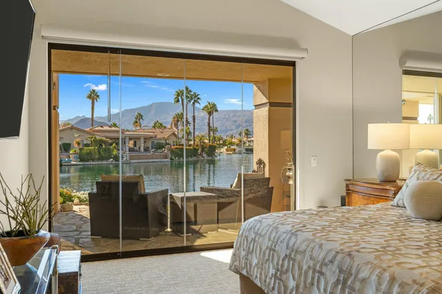 a bedroom with a bed and glass window