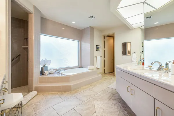 a bathroom with a double vanity sink and a mirror