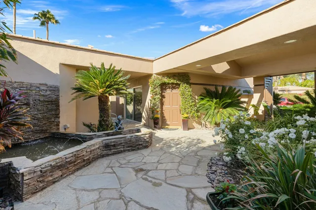 a bedroom with furniture and a chandelier