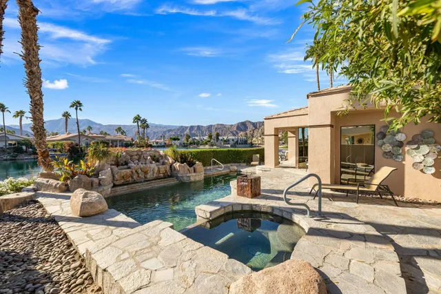 a view of a house with swimming pool and sitting area