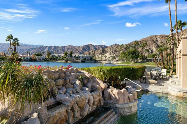 a view of a lake with a yard and a table