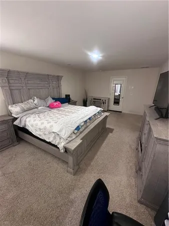 a bed sitting in a bedroom and table