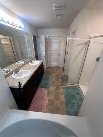 a bathroom with a sink a mirror and a shower