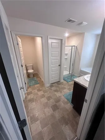 a bedroom with a bed and a lamp