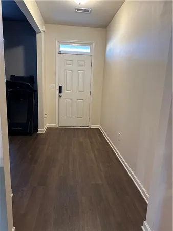 an empty room with wooden floor