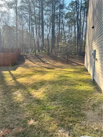 a view of a house with wooden fence