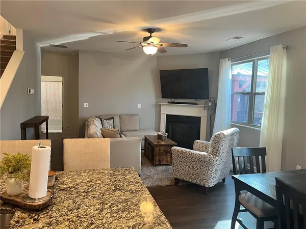 a living room with furniture a flat screen tv and a fireplace