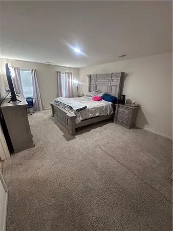 a spacious bedroom with a bed and a couch