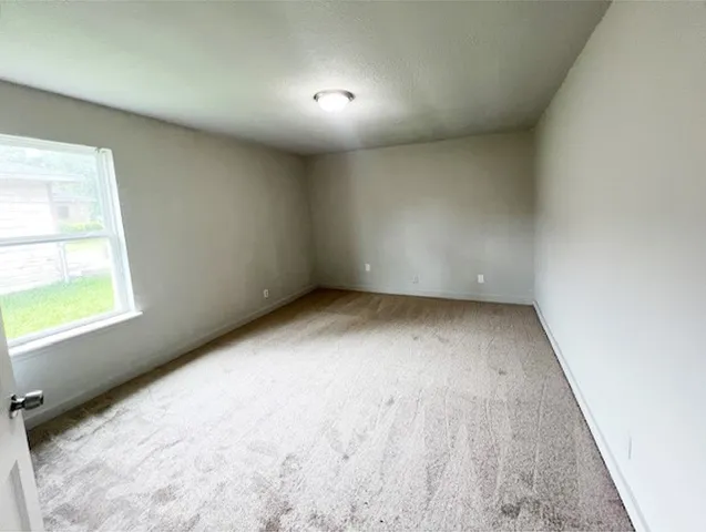a view of an empty room and a window