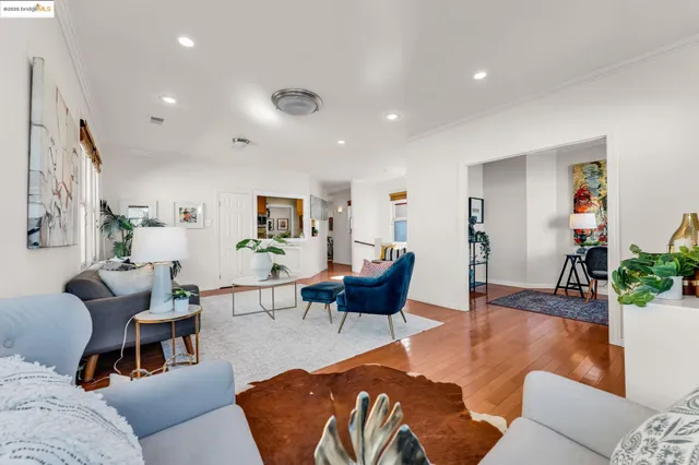 a living room with furniture or wooden floor and a large window