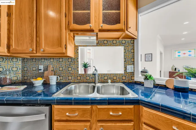 a kitchen counter with a sink and cabinets