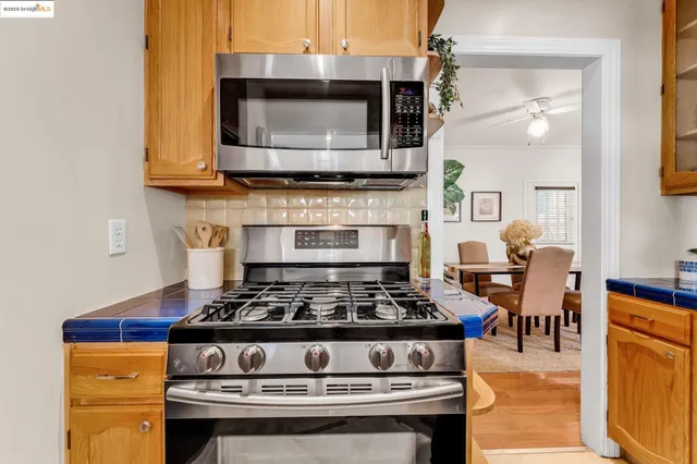 a stove top oven sitting inside of a kitchen