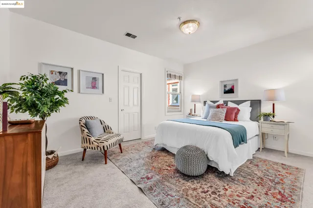 a bedroom with a bed and a chair