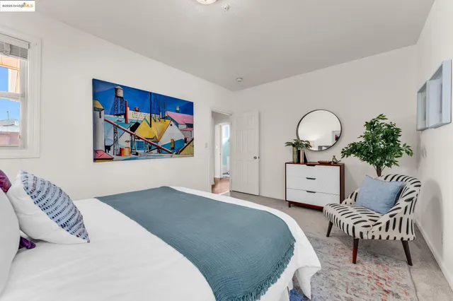 a bed room with a bed and a chair