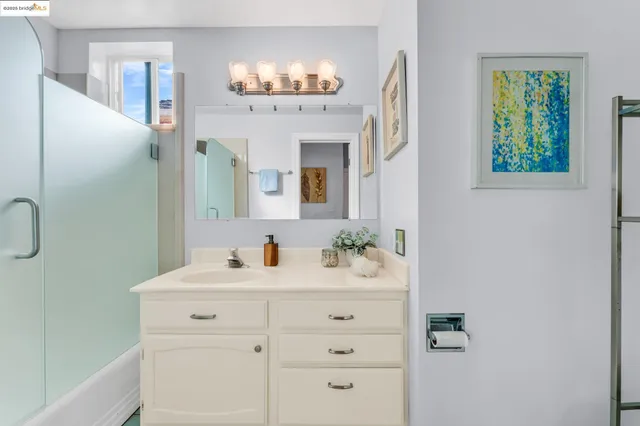 a bathroom with a sink vanity and a mirror