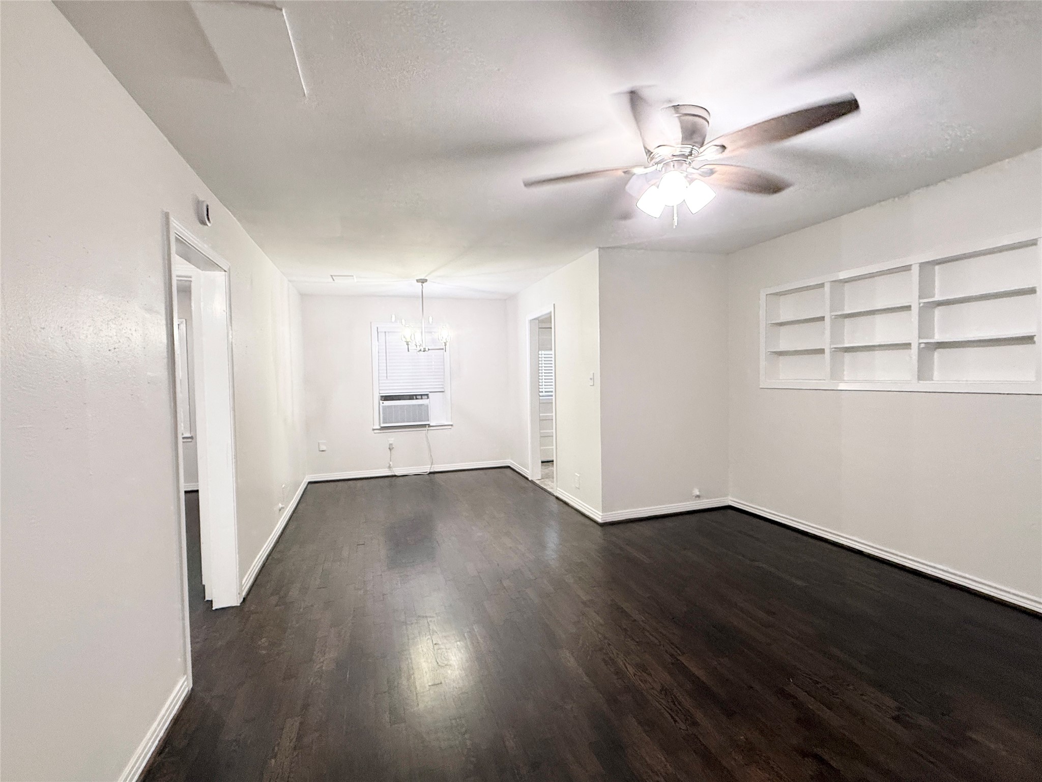832 South Anderson Street Angleton, TX 77515 - Photo 4 of 19 a view of an empty room with wooden floor and a window