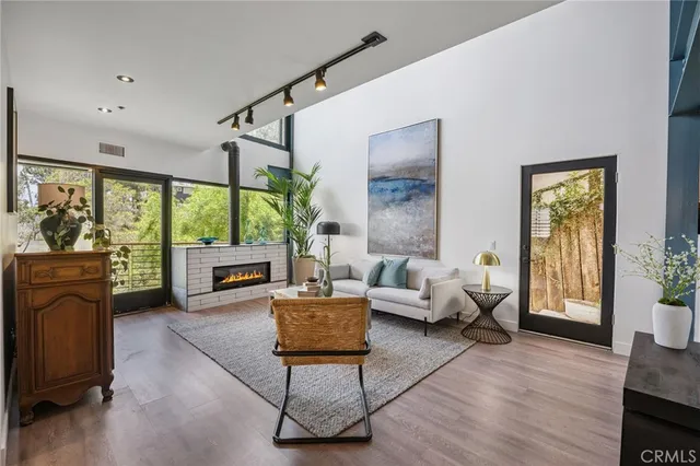 a view of a house with a tree in front of it