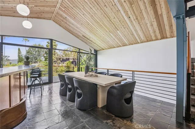 an aerial view of multiple houses with a yard