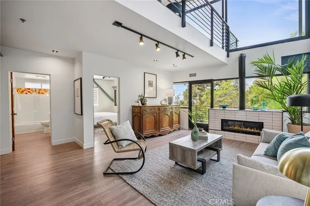 a living room with furniture and floor to ceiling windows