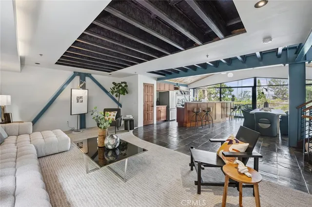 a view of a livingroom with furniture and floor to ceiling window