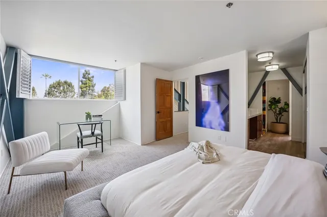 a living room with furniture a flat screen tv and a floor to ceiling window