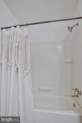 a bathroom with a shower and a tub