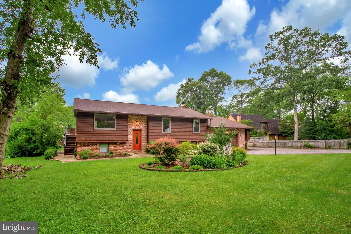 1428 Oak Bluff Road Edgewater, MD 21037 - Photo 2 of 43 a front view of a house with garden