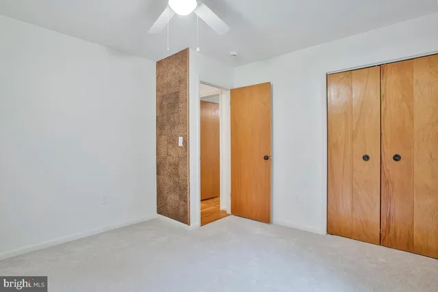 an empty room with closet area