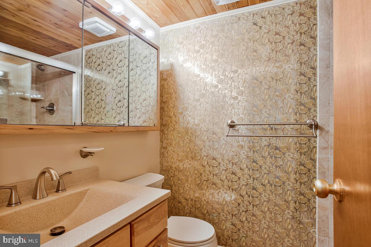 1428 Oak Bluff Road Edgewater, MD 21037 - Photo 31 of 43 a bathroom with a sink toilet and shower