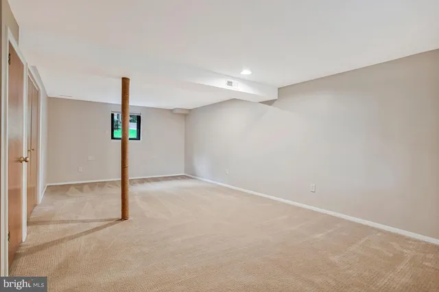 a view of a house with a yard and potted plants