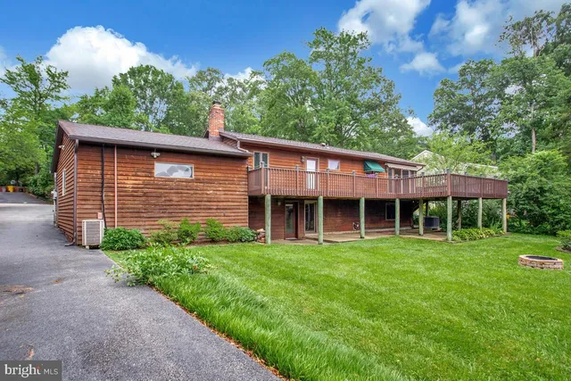 a view of a chair and table in backyard of the house