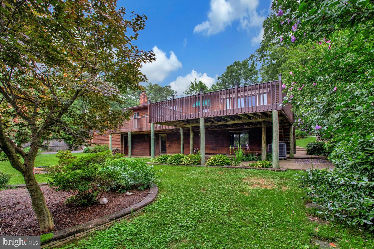 1428 Oak Bluff Road Edgewater, MD 21037 - Photo 36 of 43 a view of a house with a yard and potted plants