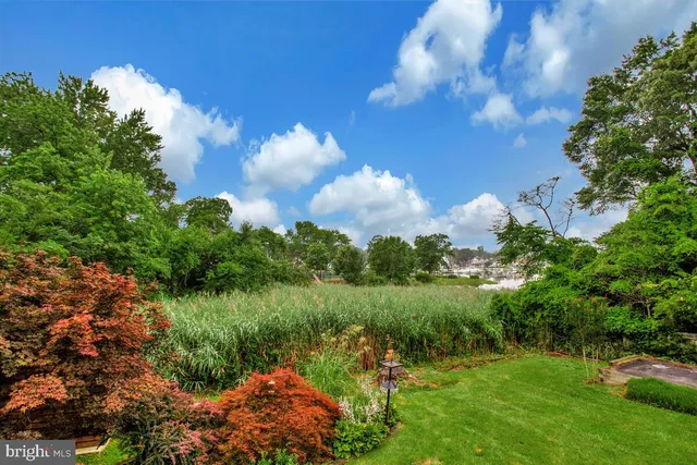 an aerial view of a house with swimming pool and patio