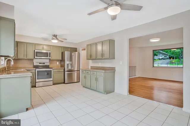 a kitchen with a stove a sink and a refrigerator
