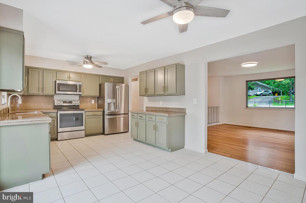 1428 Oak Bluff Road Edgewater, MD 21037 - Photo 6 of 43 a kitchen with a stove a sink and a refrigerator