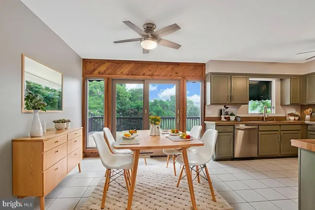 a dining room with furniture a flat screen tv and a large window