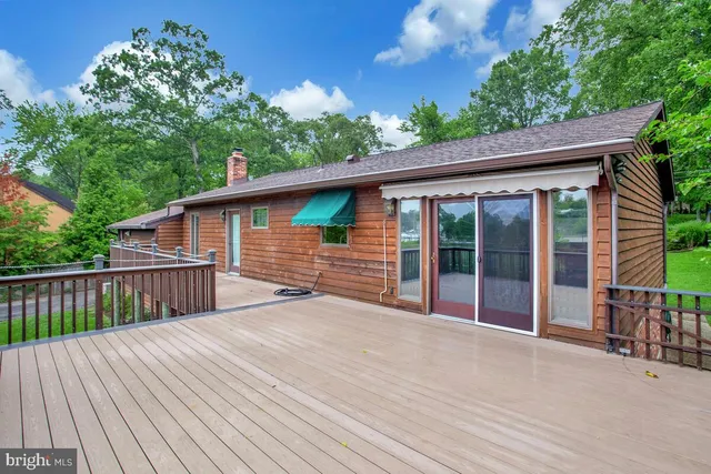 a view of backyard with a deck and wooden floor