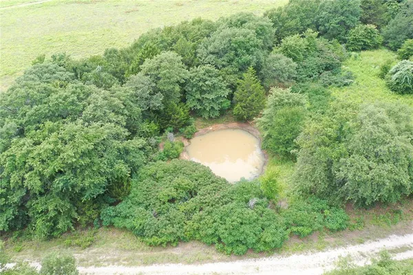 a aerial view of a house with a yard and lake view