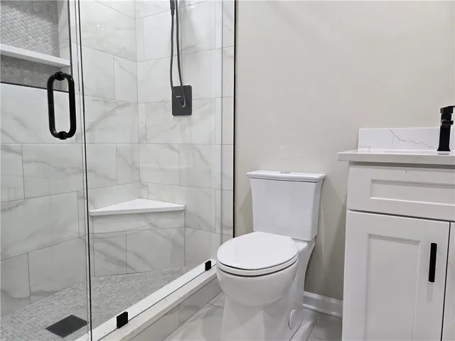 a bathroom with a toilet and a shower