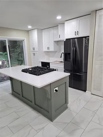 a kitchen with granite countertop a cabinets and steel stainless steel appliances with cabinets
