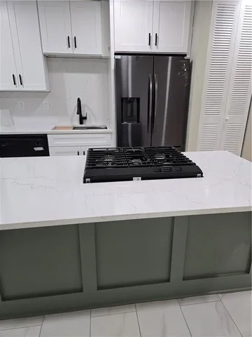 a kitchen with a sink and a refrigerator
