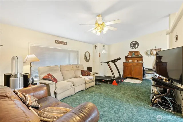 a living room with furniture a air conditioner and a large window