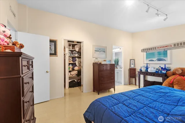 a bedroom with a bed a dresser and a book shelf