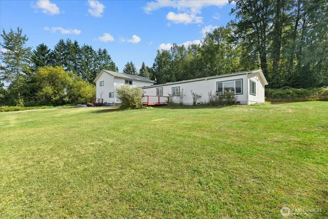 a view of backyard of house with green space